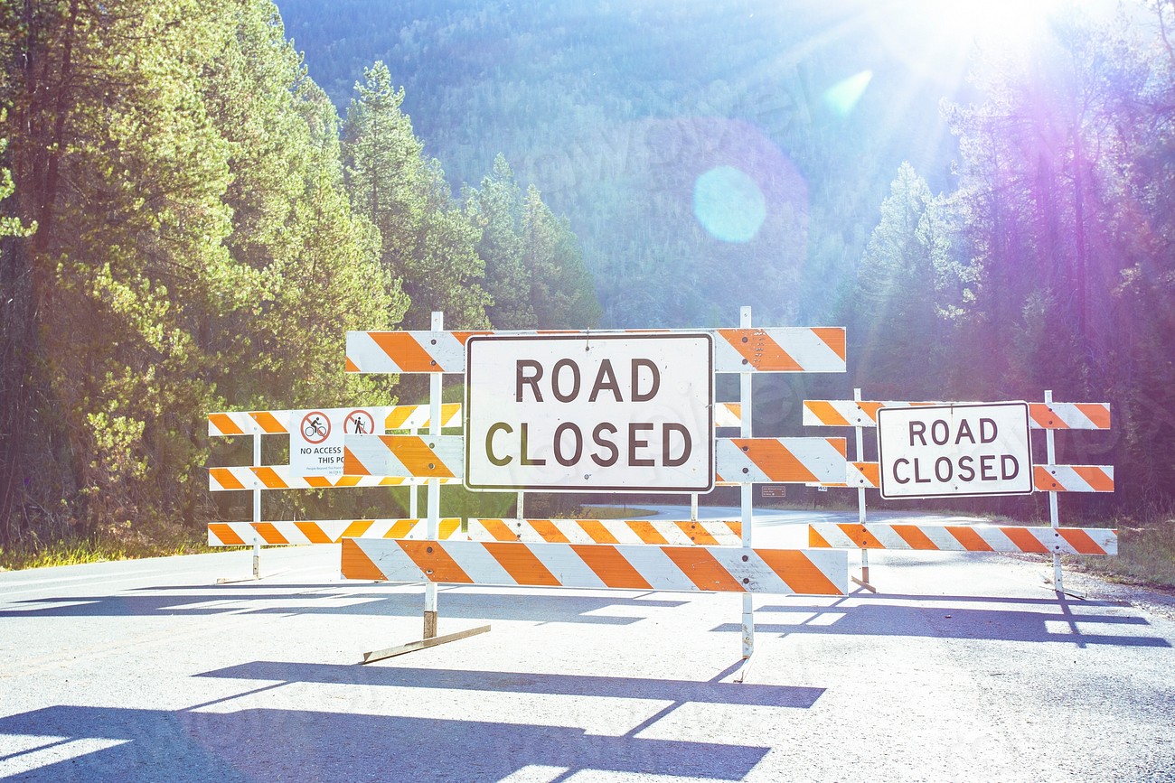 a road closed sign on a road