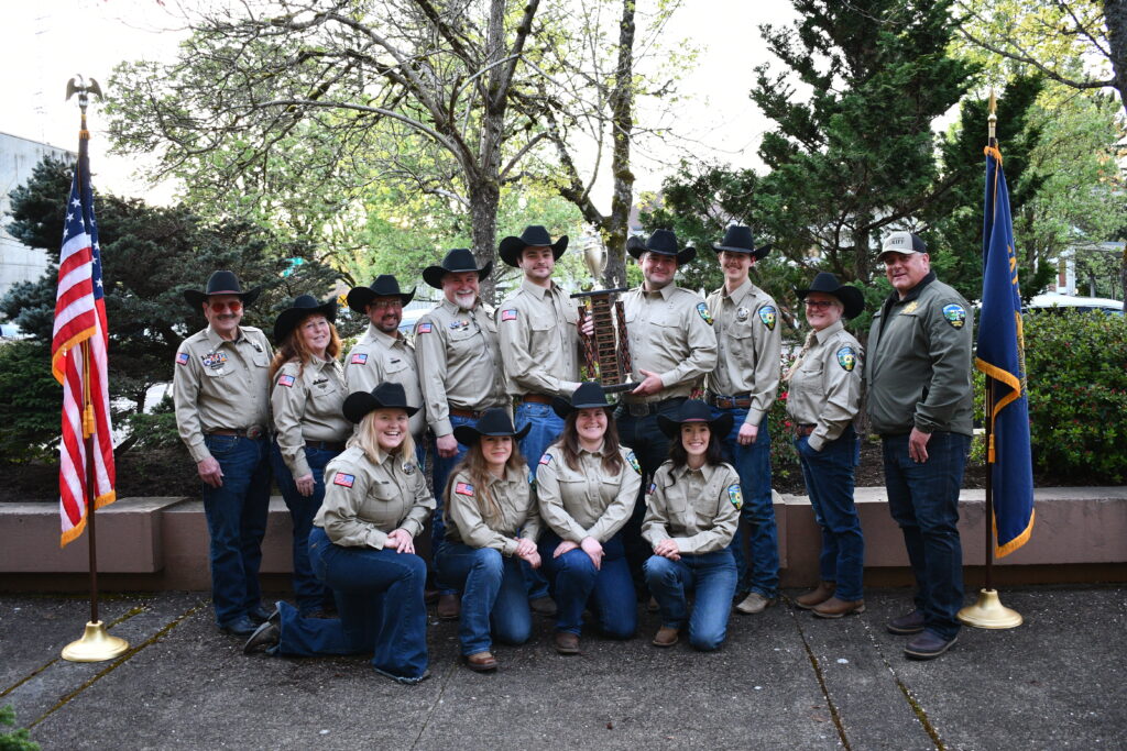 The Benton County Sheriff's Mounted Posse poses with the 2024 O.A.M.P. Sportsmanship Trophy. March 2025.