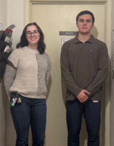 Man and woman standing in front of door.